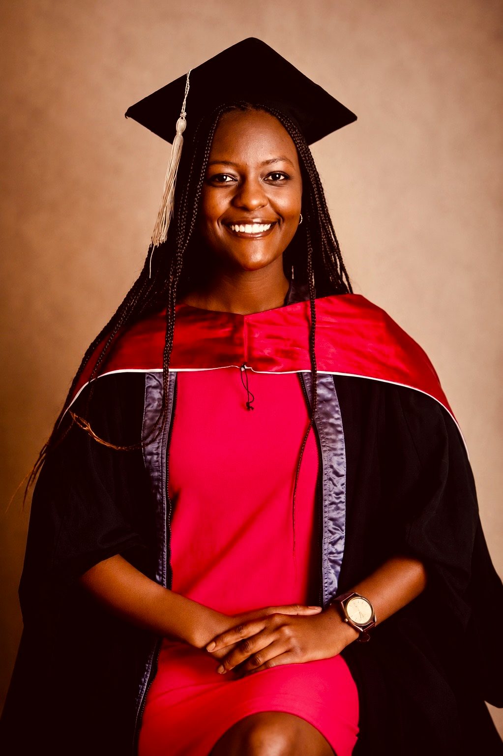 Njoki Kangethe in cap and gown at her graduation, smiling.