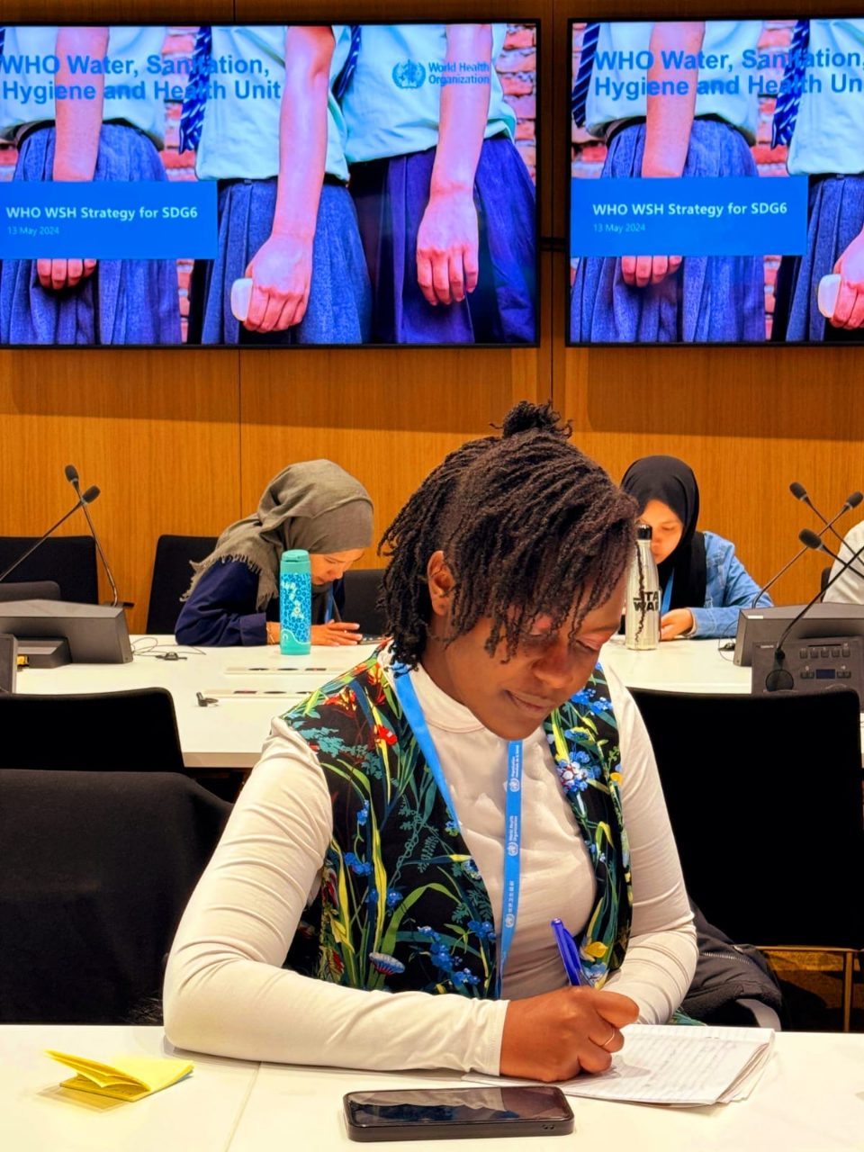 Njoki taking notes at the WHO Water, Sanitation, Hygiene and Health session in Geneva.
